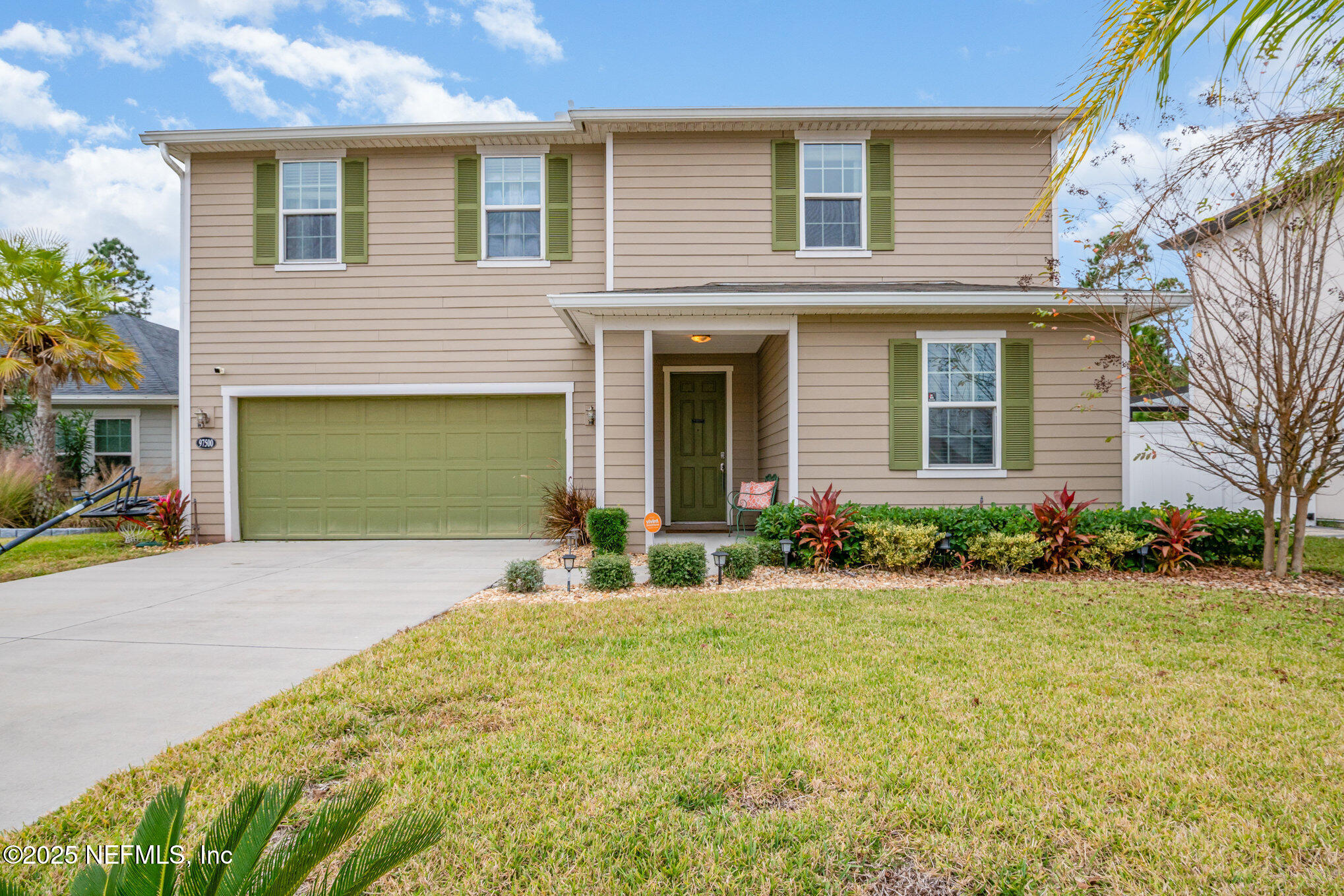 97500 Albatross Drive Yulee, FL 32097 - Photo 1 of 28 a front view of a house with garden