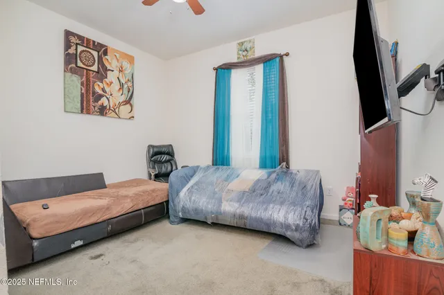 a bedroom with two beds and a flat screen tv