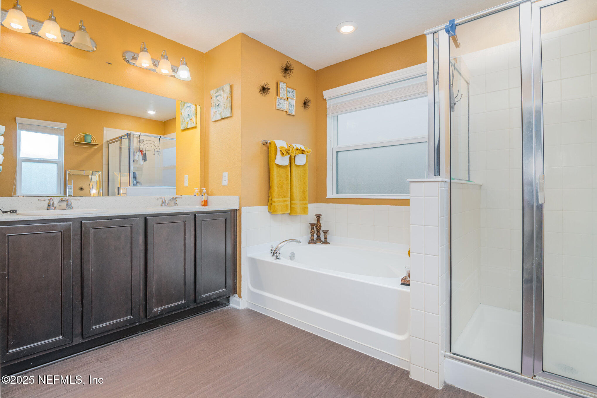 97500 Albatross Drive Yulee, FL 32097 - Photo 16 of 28 a bathroom with a tub a sink and a large mirror