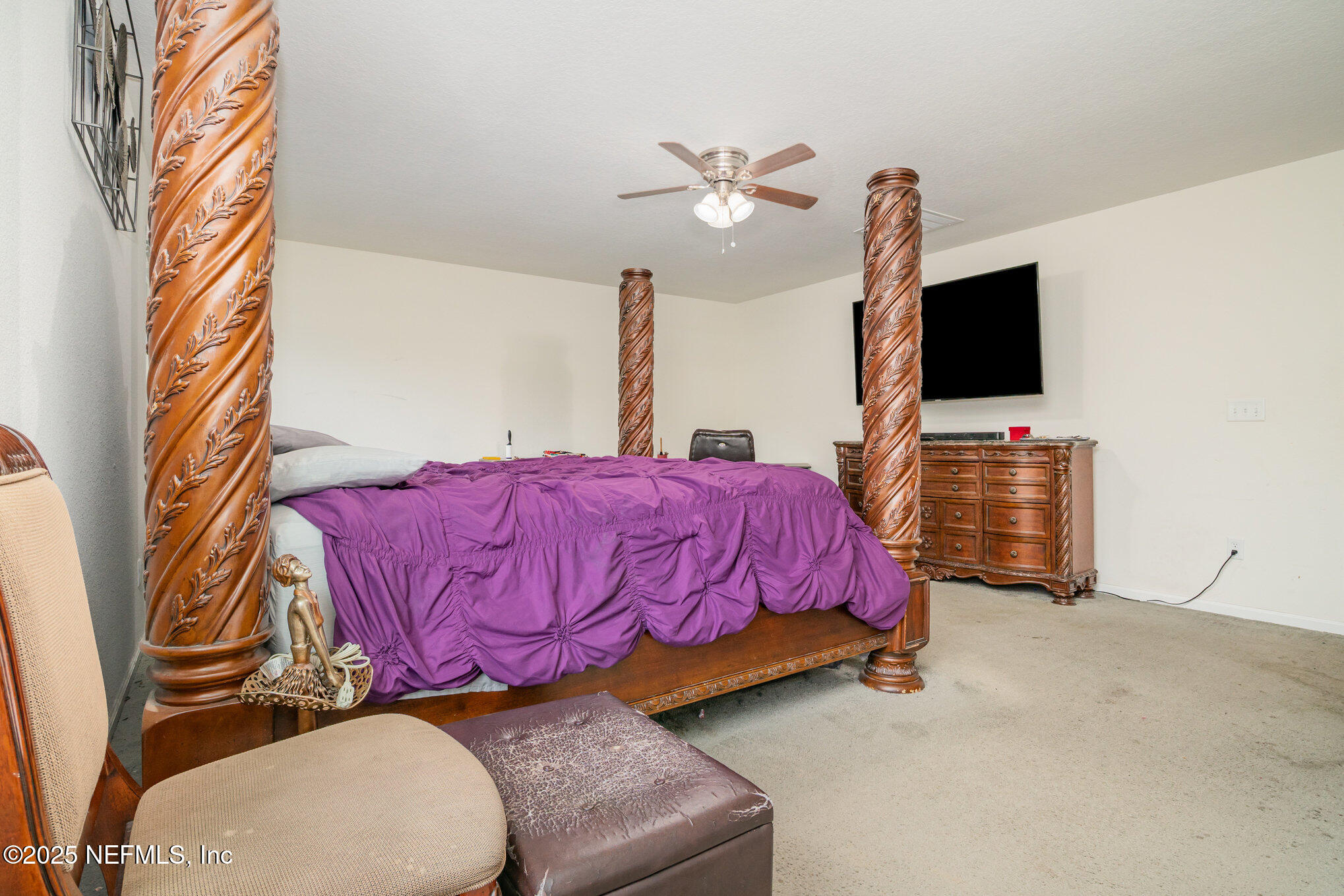 97500 Albatross Drive Yulee, FL 32097 - Photo 19 of 28 a bedroom with a bed and flat screen tv
