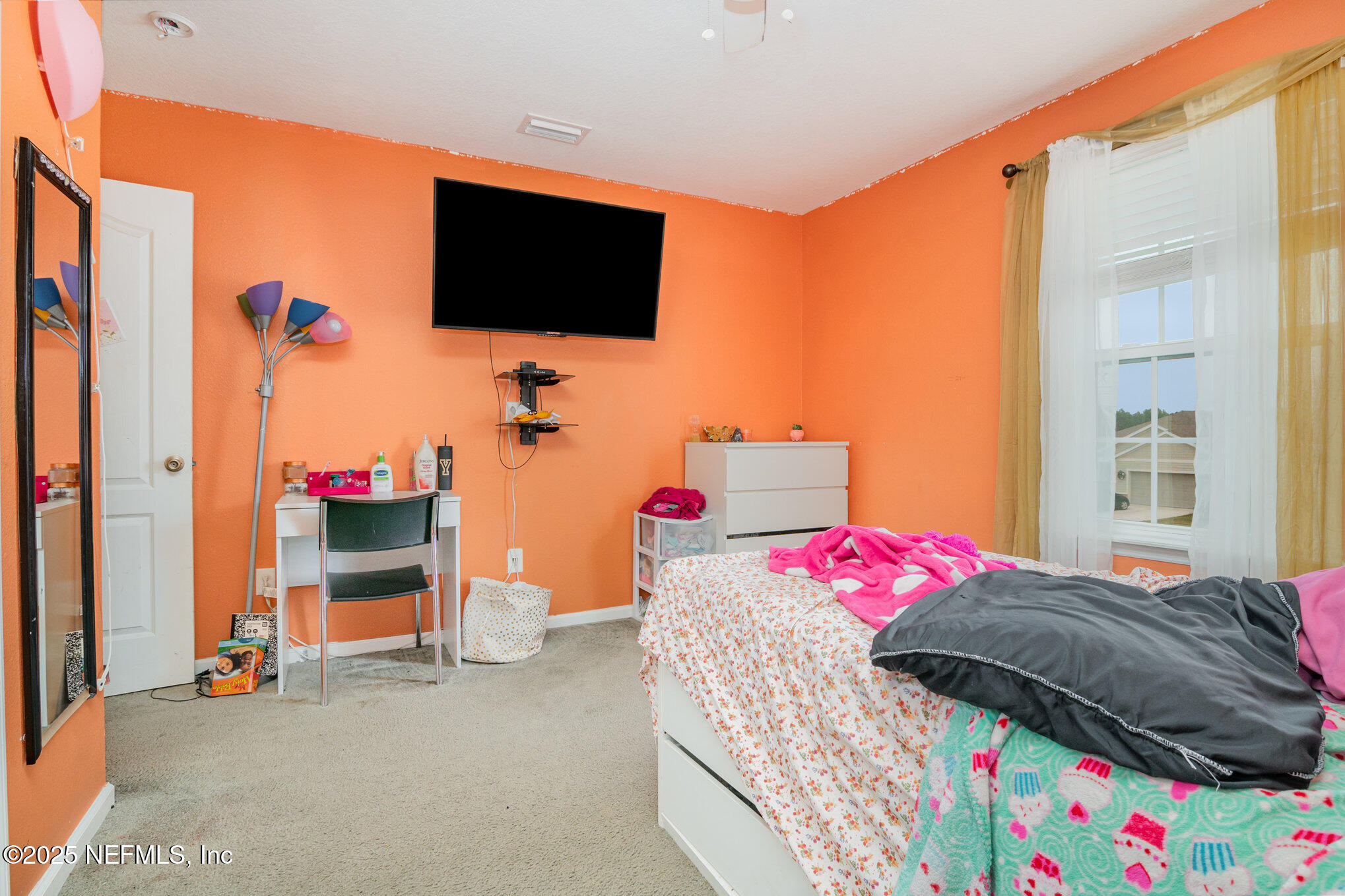 97500 Albatross Drive Yulee, FL 32097 - Photo 25 of 28 a bedroom with a bed and flat screen tv