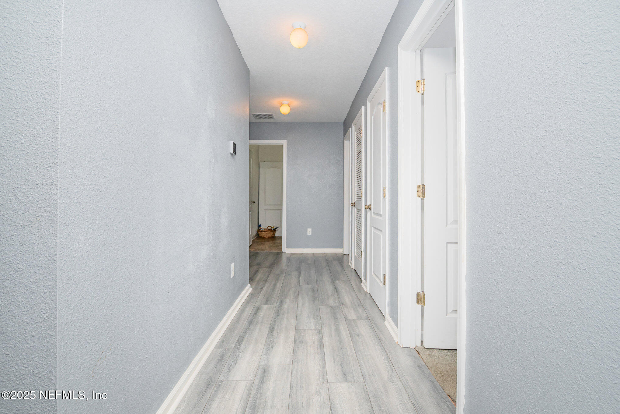 97500 Albatross Drive Yulee, FL 32097 - Photo 3 of 28 a view of a hallway with wooden floor