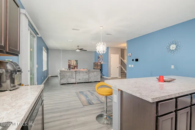 a living room with furniture and a kitchen