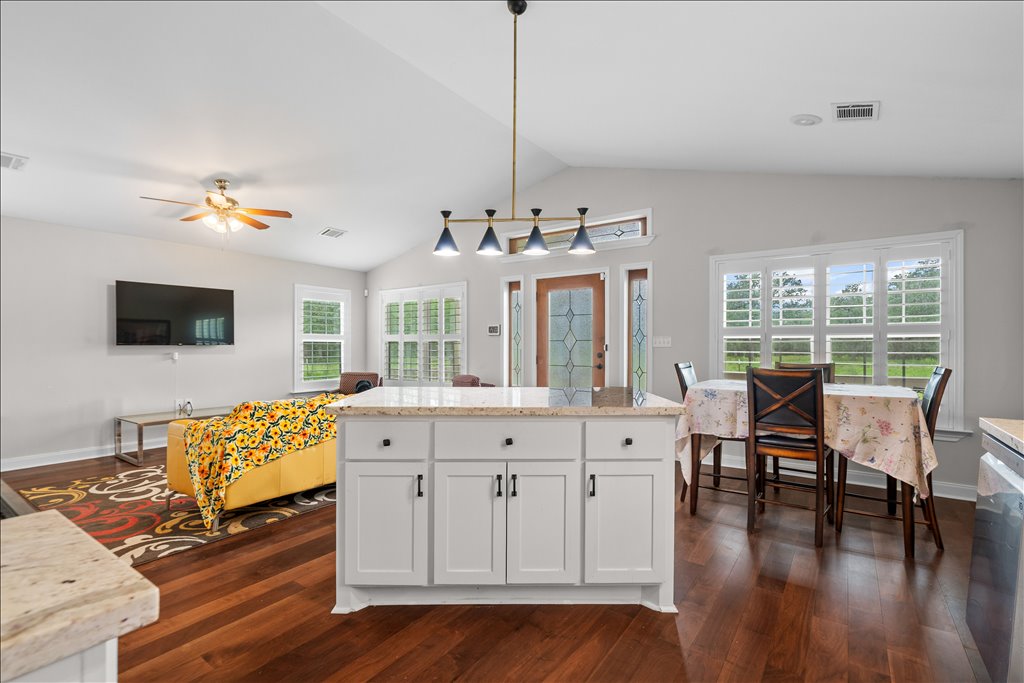 608 Whistleville Road Flatonia, TX 78941 - Photo 6 of 26 Standing at the island, you can see just how great this home is for entertaining. Your dining table fits comfortably by the window, and you have a clear view into the living room.