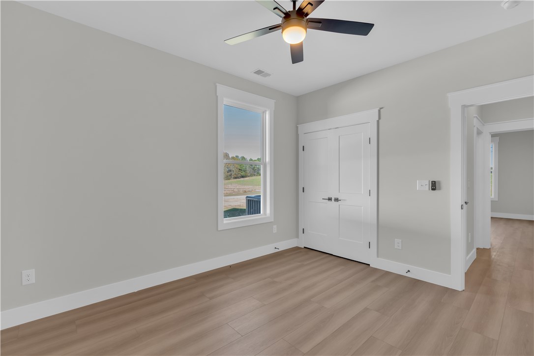 516 Lakeside Drive Anderson, SC 29621 - Photo 12 of 32 A quiet bedroom showcases a bright window and smooth wooden-style flooring.