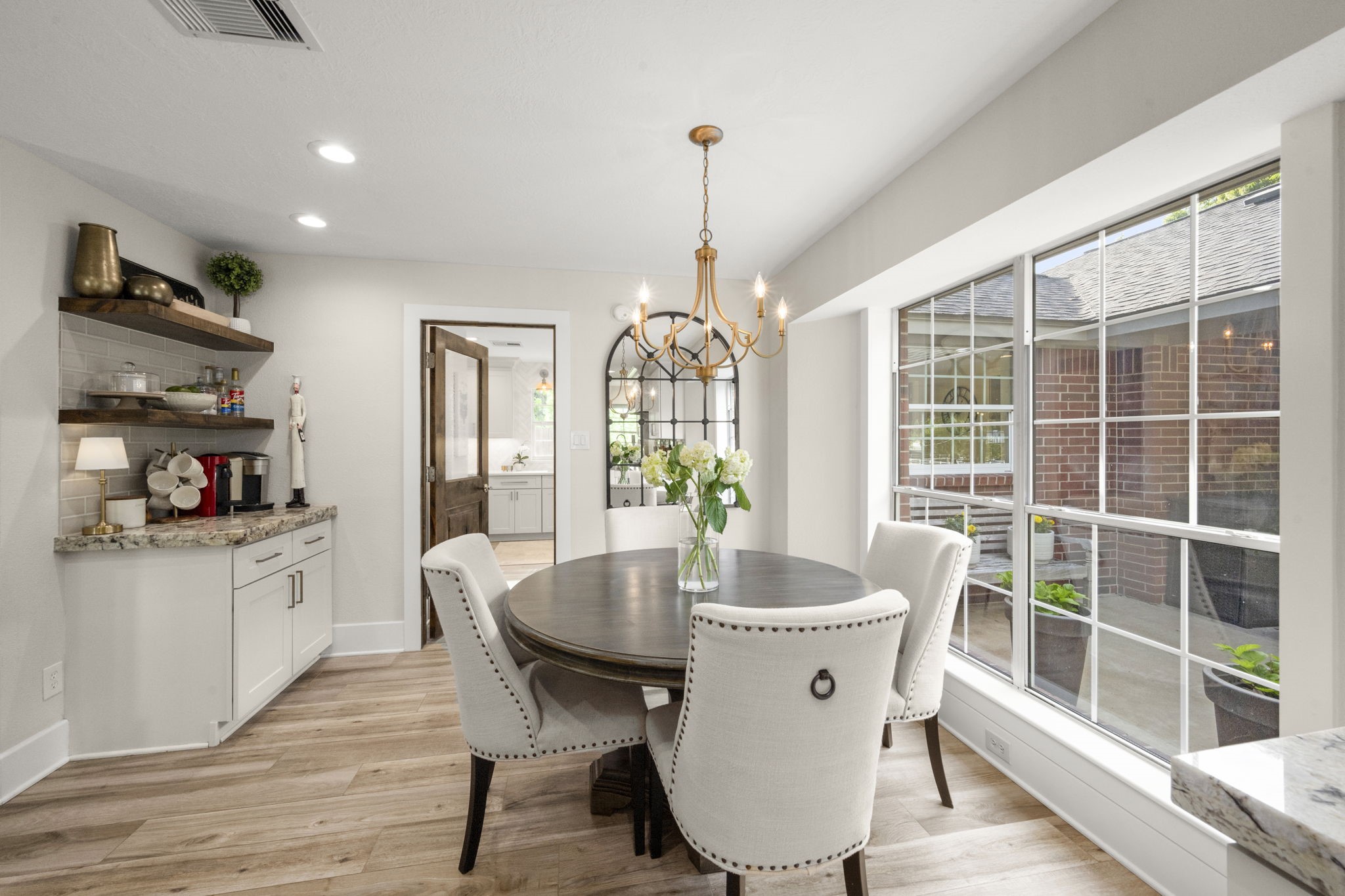 8555 Matthews Lane Magnolia, TX 77354 - Photo 12 of 37 a dining room with wooden floor a chandelier a wooden table and chairs