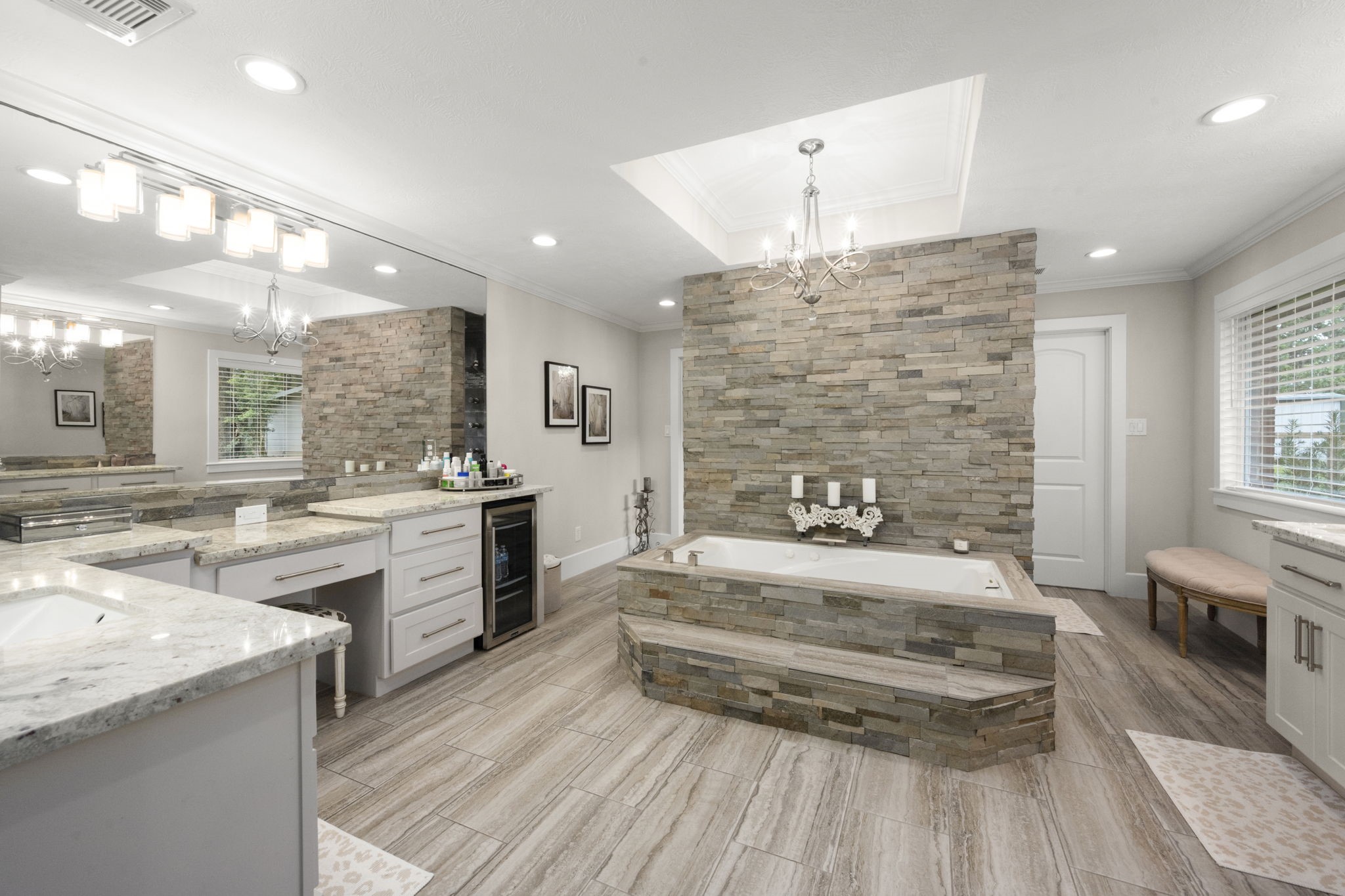 8555 Matthews Lane Magnolia, TX 77354 - Photo 19 of 37 a spacious bathroom with a granite countertop sink mirror and a bathtub