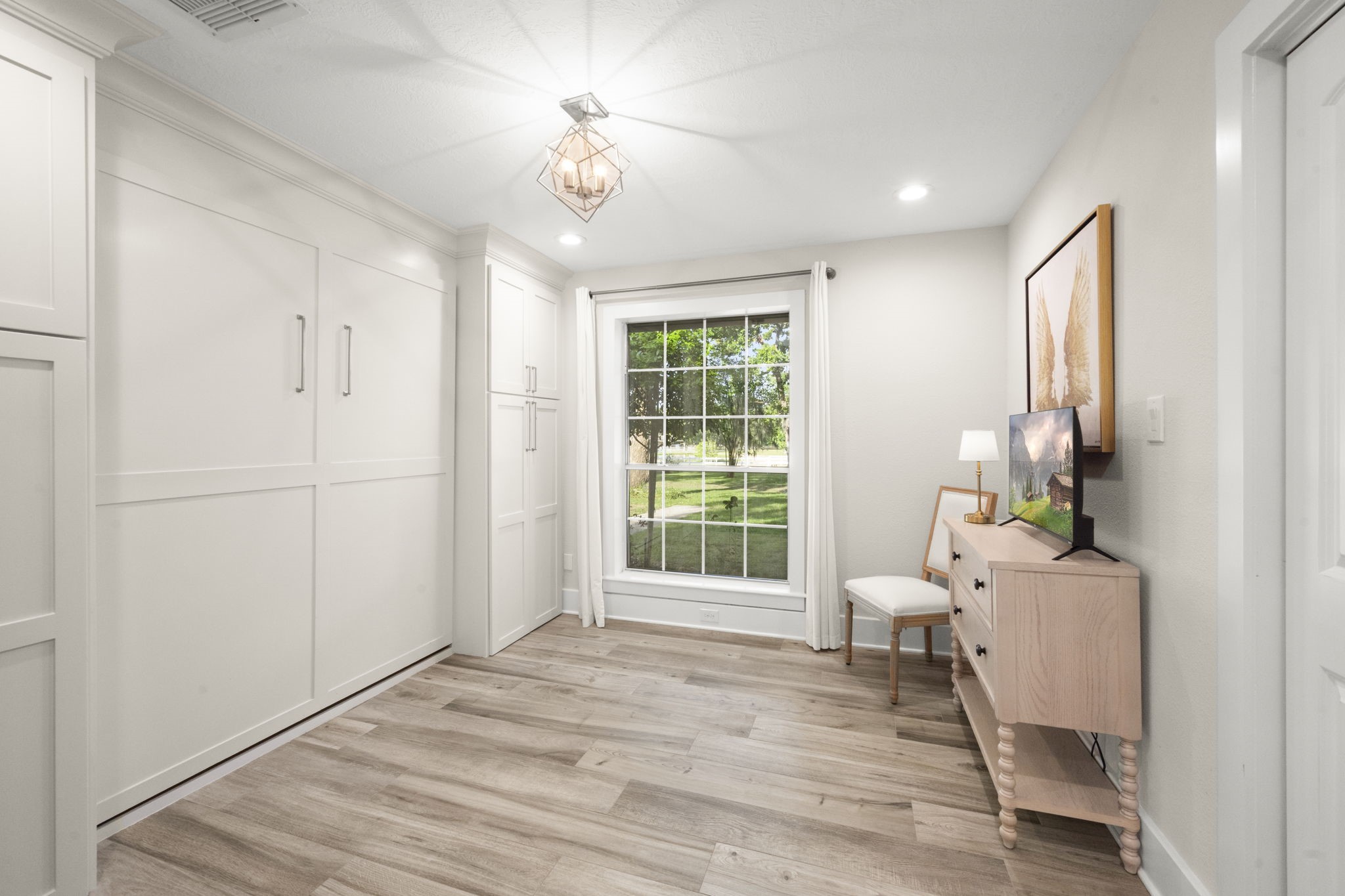 8555 Matthews Lane Magnolia, TX 77354 - Photo 23 of 37 a view of an empty room with a window and wooden floor