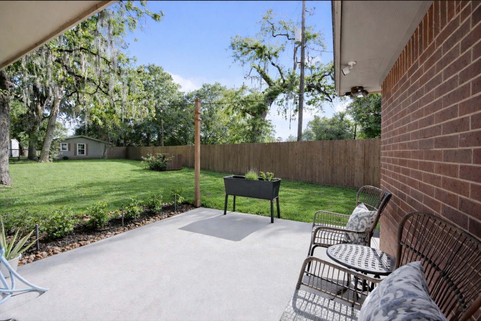8555 Matthews Lane Magnolia, TX 77354 - Photo 26 of 37 a view of a backyard with furniture and a garden