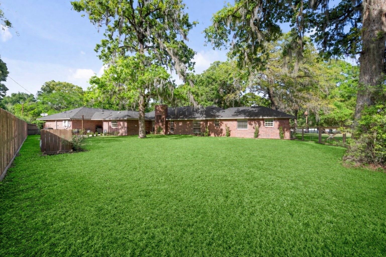 8555 Matthews Lane Magnolia, TX 77354 - Photo 27 of 37 a backyard of a house with table and chairs and a large tree