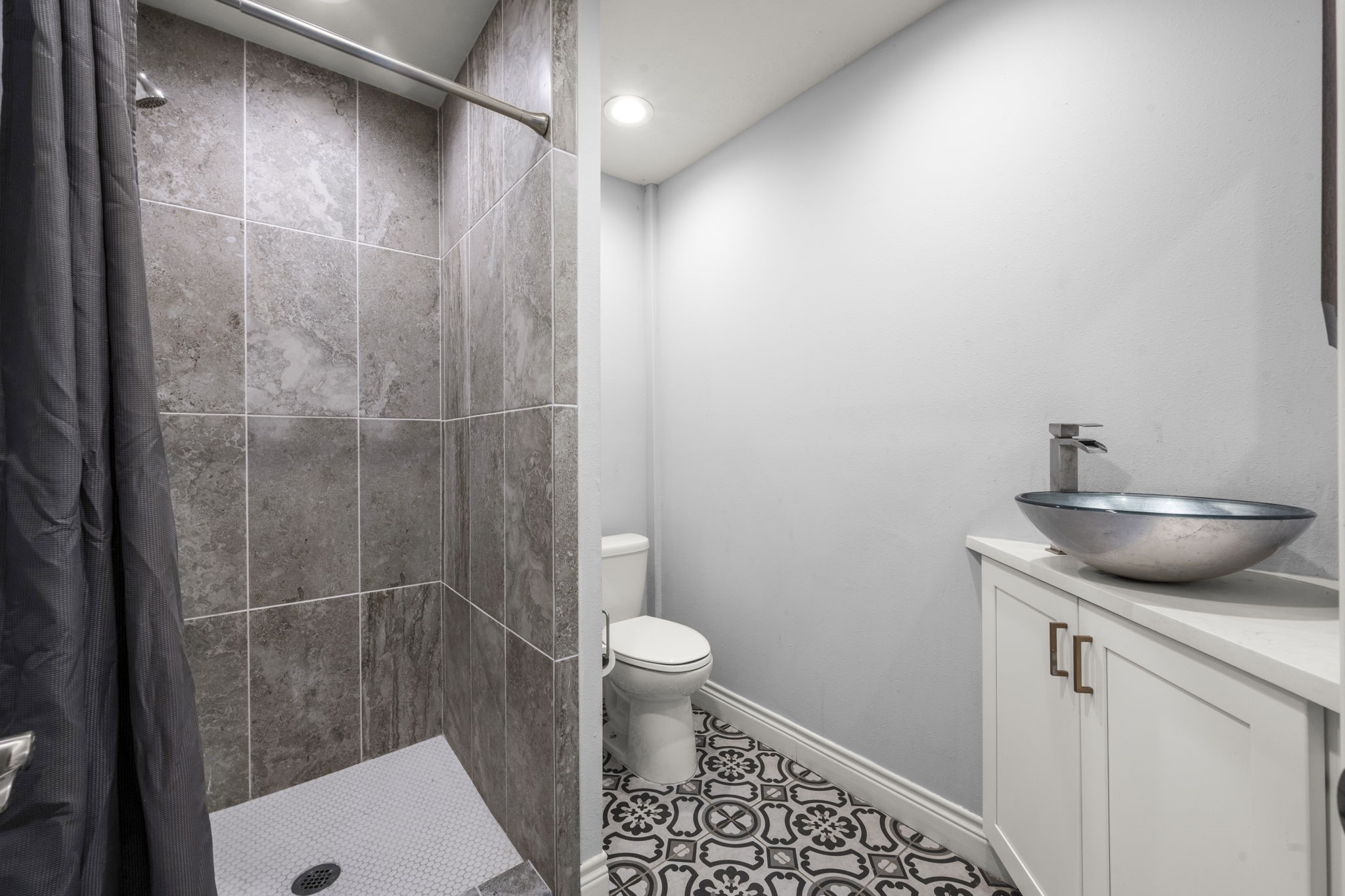 8555 Matthews Lane Magnolia, TX 77354 - Photo 31 of 37 a bathroom with a granite countertop sink toilet and shower