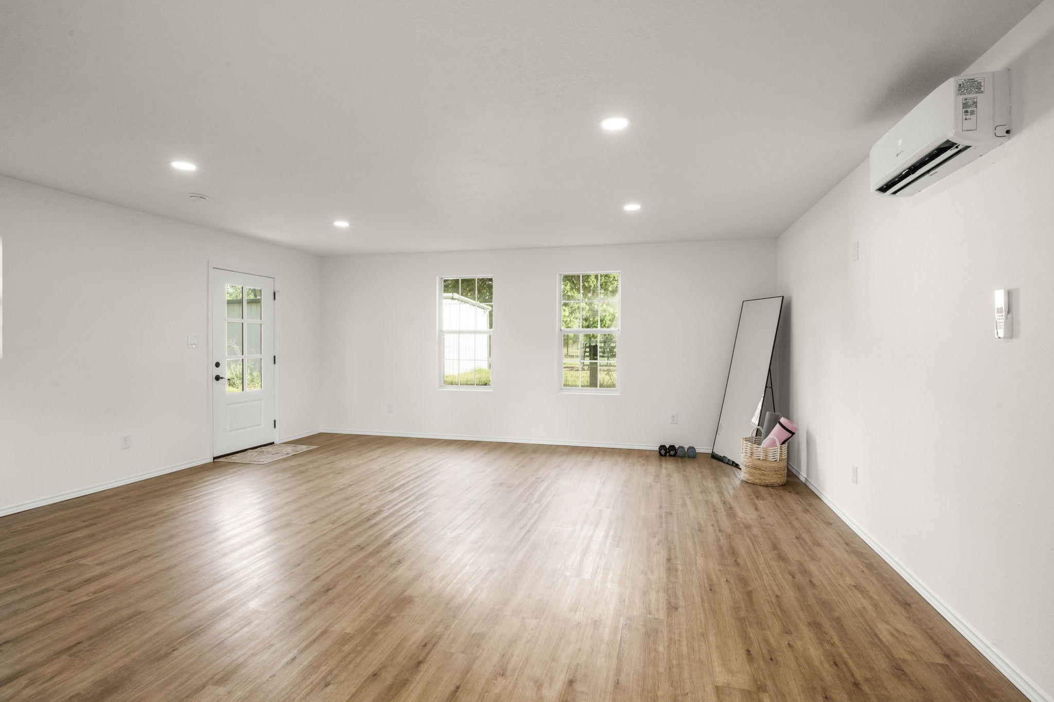 8555 Matthews Lane Magnolia, TX 77354 - Photo 37 of 37 an empty room with wooden floor and windows