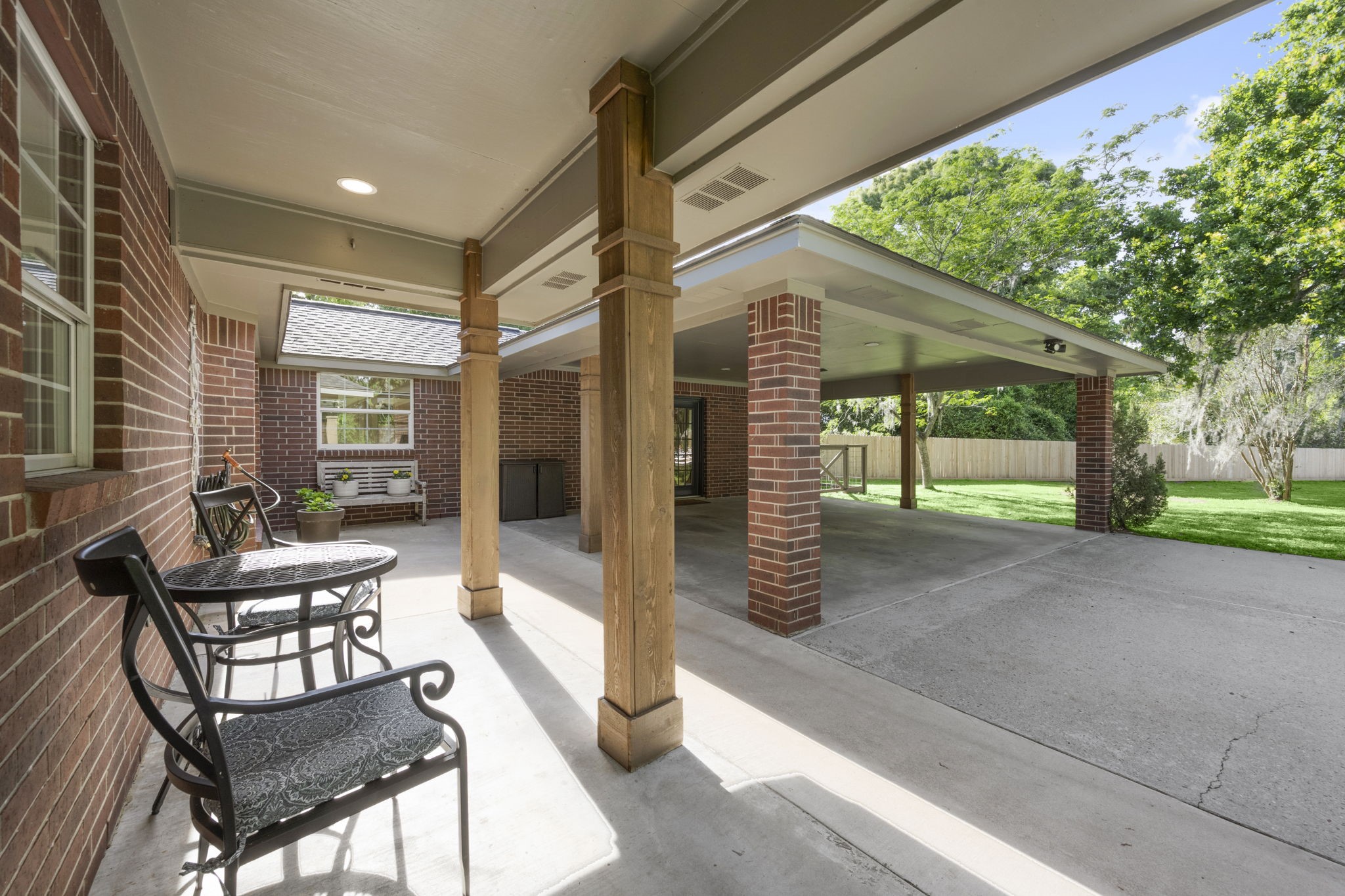 8555 Matthews Lane Magnolia, TX 77354 - Photo 5 of 37 a porch with a bench and chairs