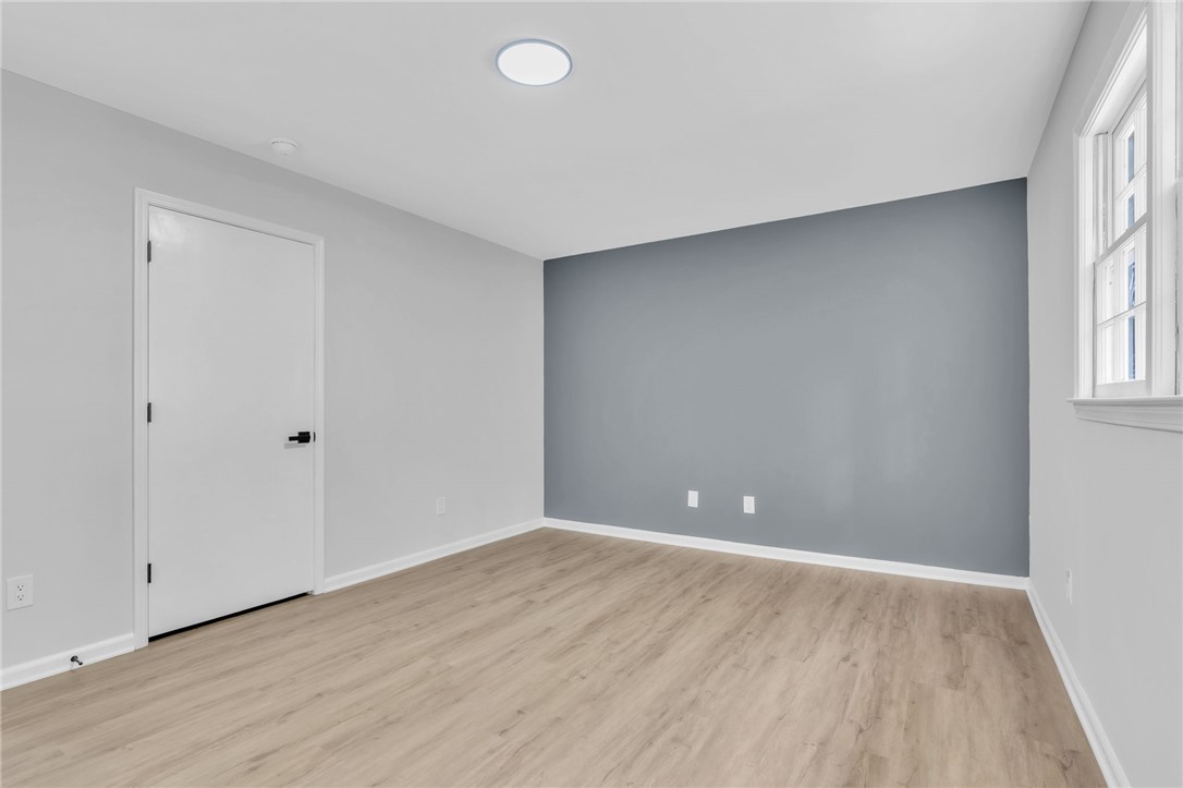 403 Keith Lane Seneca, SC 29678 - Photo 11 of 28 This spacious room features ample natural light and durable flooring, offering a versatile living space.