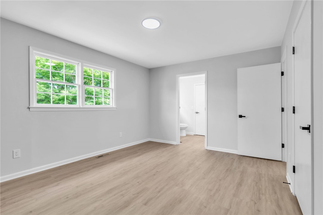 403 Keith Lane Seneca, SC 29678 - Photo 13 of 28 This spacious bedroom offers ample natural light and direct access to a private bathroom.