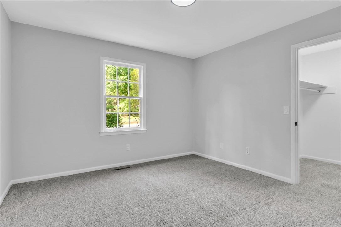 403 Keith Lane Seneca, SC 29678 - Photo 22 of 28 This spacious room features a bright window and soft carpeting, perfect for a cozy living space.
