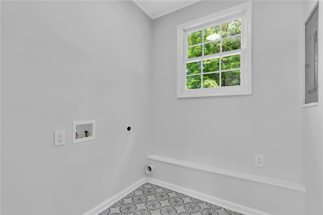 403 Keith Lane Seneca, SC 29678 - Photo 23 of 28 Bright laundry space with patterned flooring and a window offering refreshing natural light.