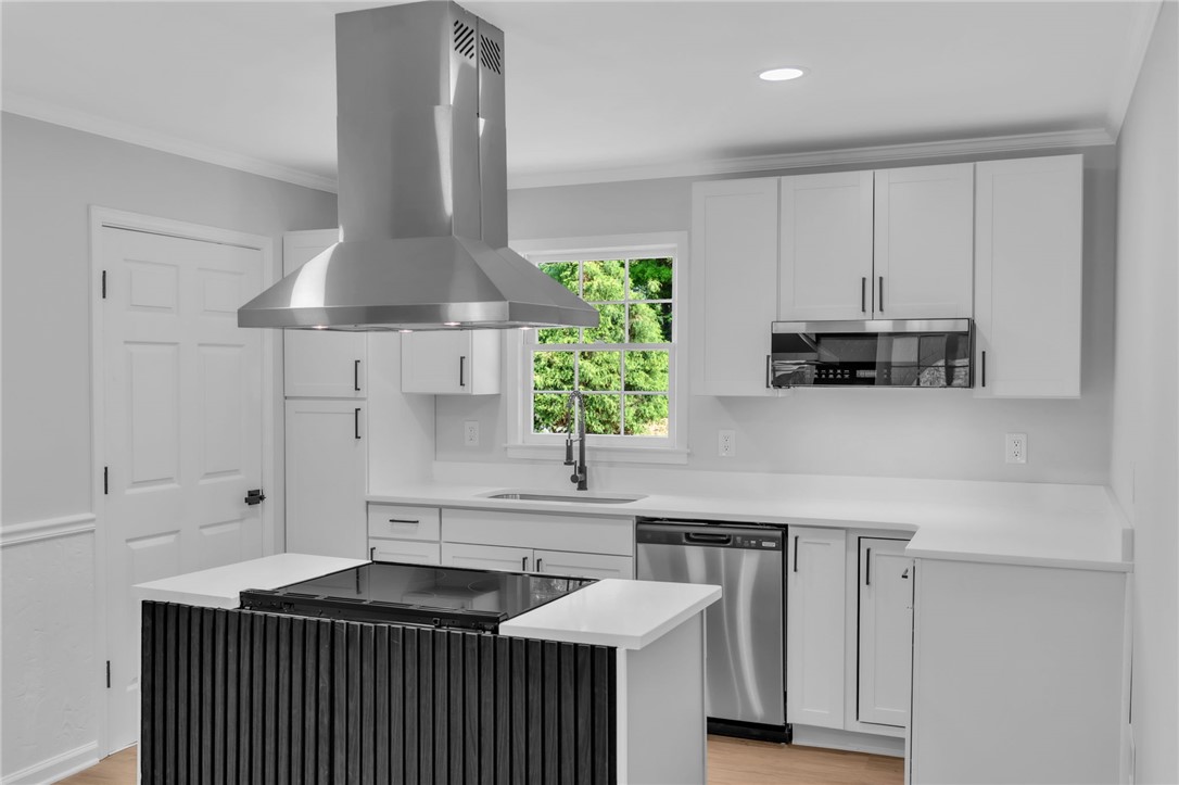 403 Keith Lane Seneca, SC 29678 - Photo 4 of 28 This newly renovated kitchen features a modern range hood and a spacious center island.