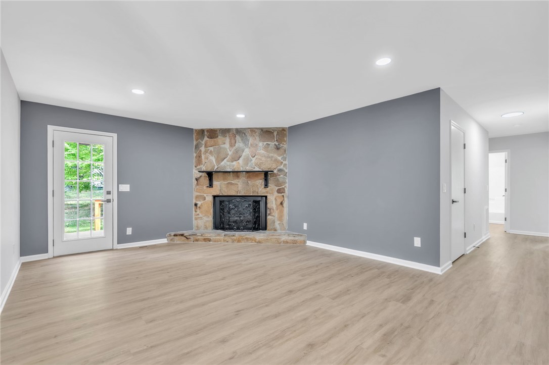 403 Keith Lane Seneca, SC 29678 - Photo 5 of 28 This bright living space features a stone fireplace, creating an inviting atmosphere.