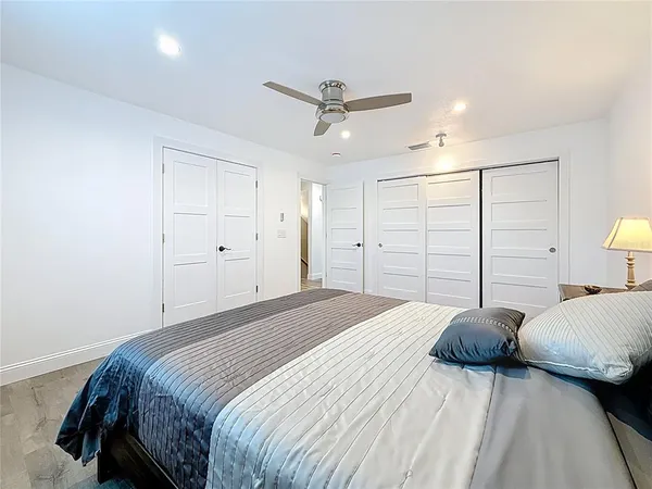a bedroom with a bed and wooden floor