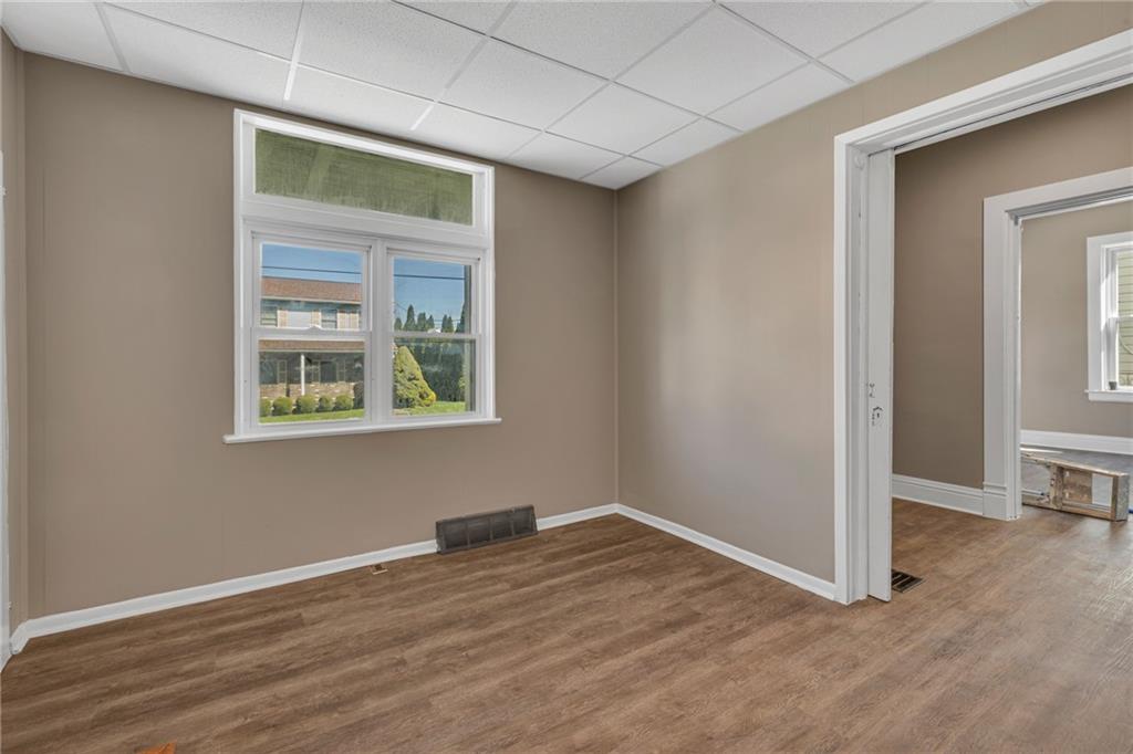 427 Jackson Street Rochester, PA 15074 - Photo 11 of 20 an empty room with wooden floor and windows