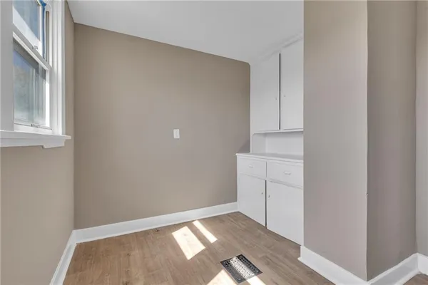 a view of an empty room with cabinet