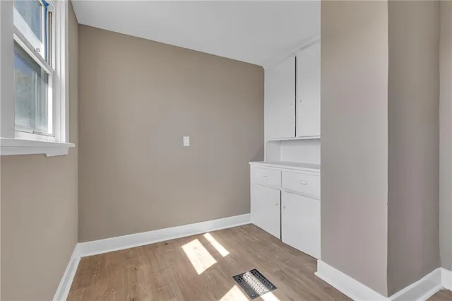 a view of an empty room with cabinet