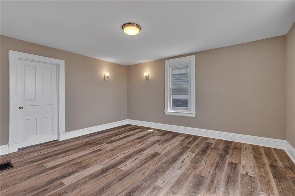 427 Jackson Street Rochester, PA 15074 - Photo 14 of 20 a view of empty room with wooden floor and fan