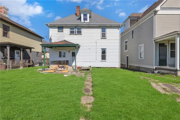 a front view of a house with a yard porch and outdoor seating