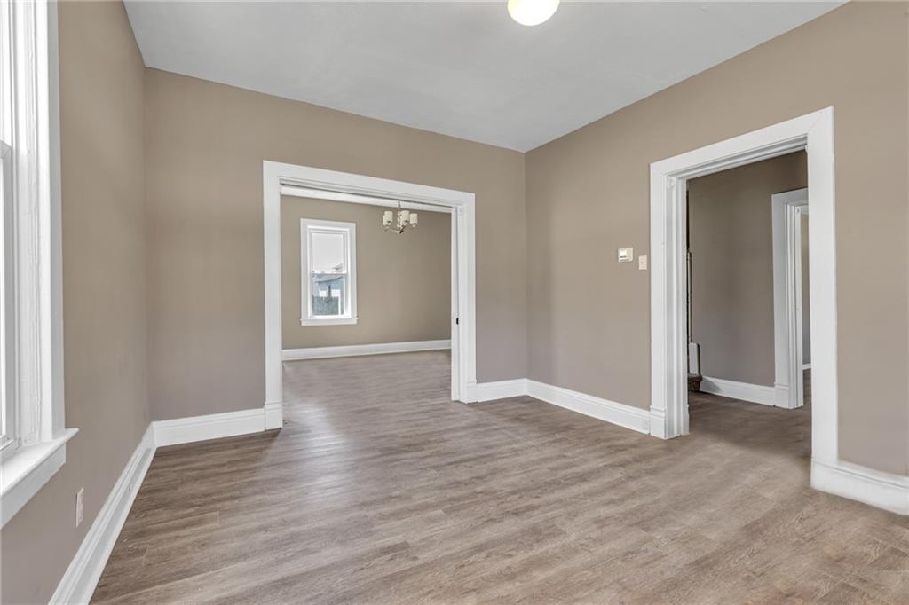 427 Jackson Street Rochester, PA 15074 - Photo 3 of 20 a view of an empty room with wooden floor and a window