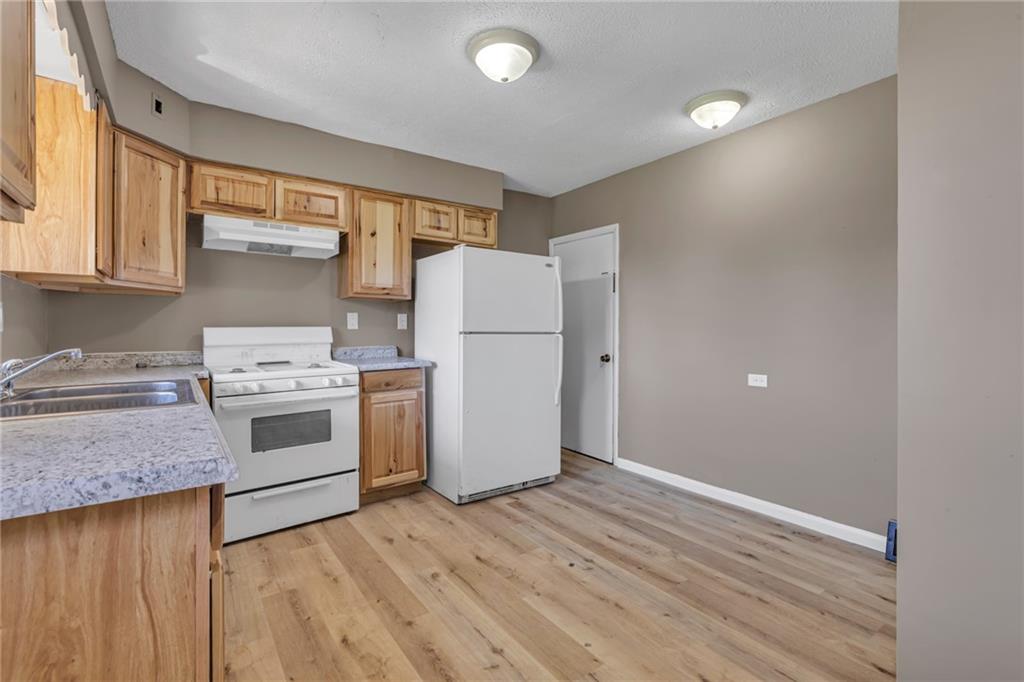 427 Jackson Street Rochester, PA 15074 - Photo 6 of 20 a kitchen with a white stove top oven and refrigerator