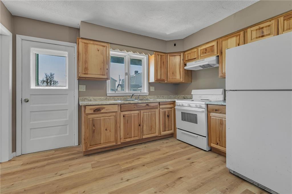 427 Jackson Street Rochester, PA 15074 - Photo 7 of 20 a kitchen with white cabinets and white appliances