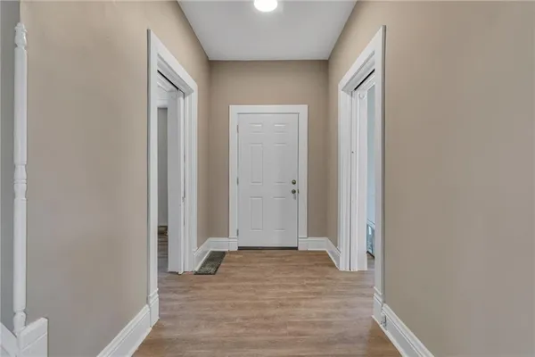 a view of a room with wooden floor