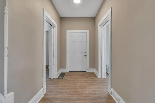a view of a room with wooden floor