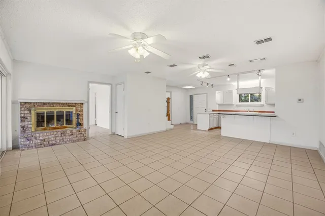 wooden floor in an empty room with a bathroom