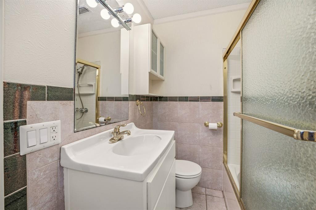 216 Broken Arrow Comanche, TX 76442 - Photo 17 of 38 a bathroom with a sink a toilet and shower