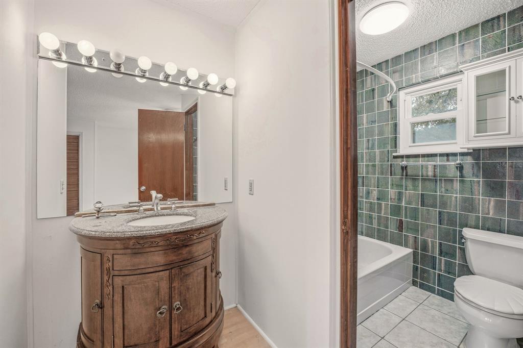 216 Broken Arrow Comanche, TX 76442 - Photo 25 of 38 a bathroom with a sink a toilet a mirror and shower