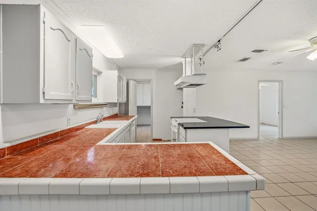 a kitchen with a sink and cabinets