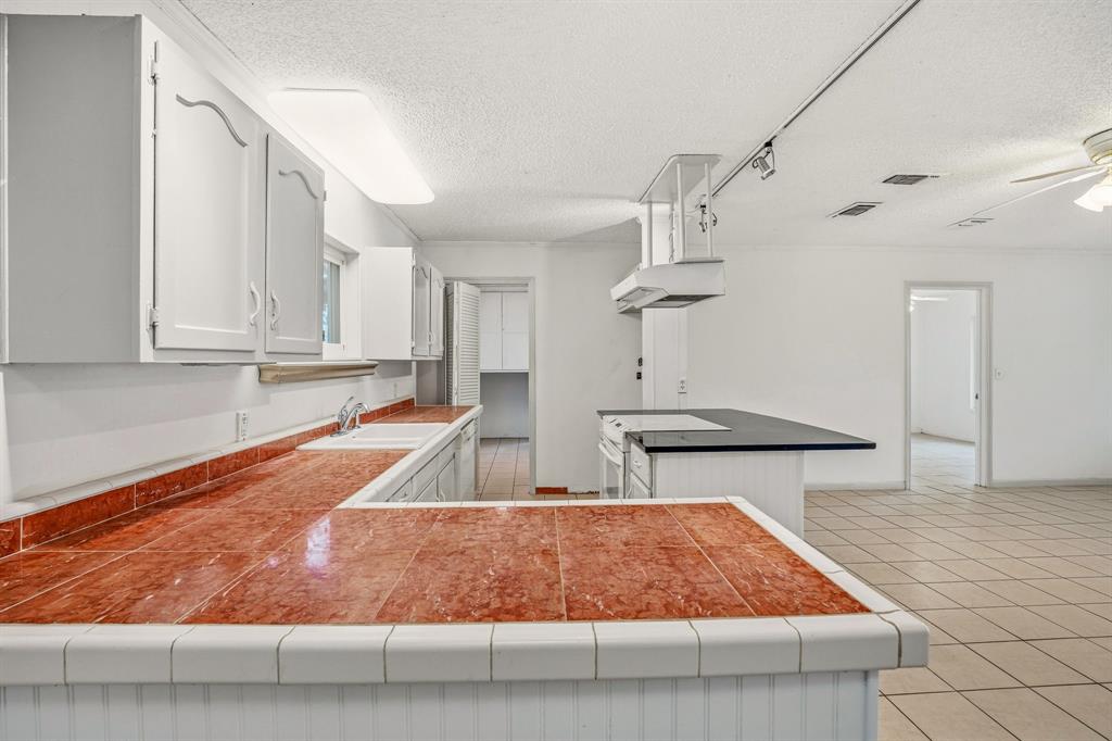 216 Broken Arrow Comanche, TX 76442 - Photo 9 of 38 a room with lots of appliances and cabinets