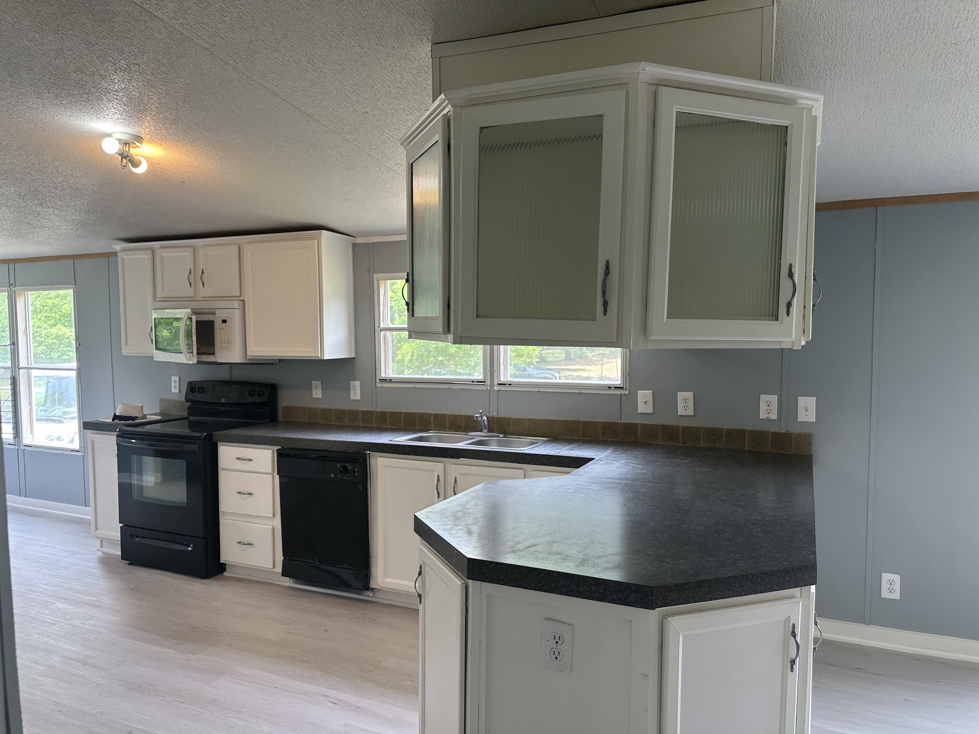 2229 Meekins Road Cleveland, TX 77328 - Photo 9 of 48 a kitchen with granite countertop a sink and cabinets