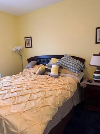 a bed sitting in a bedroom next to a window