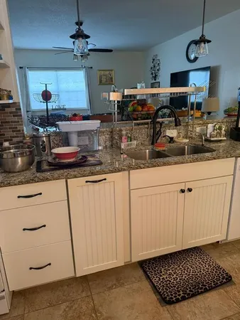 a stove top oven sitting inside of a kitchen