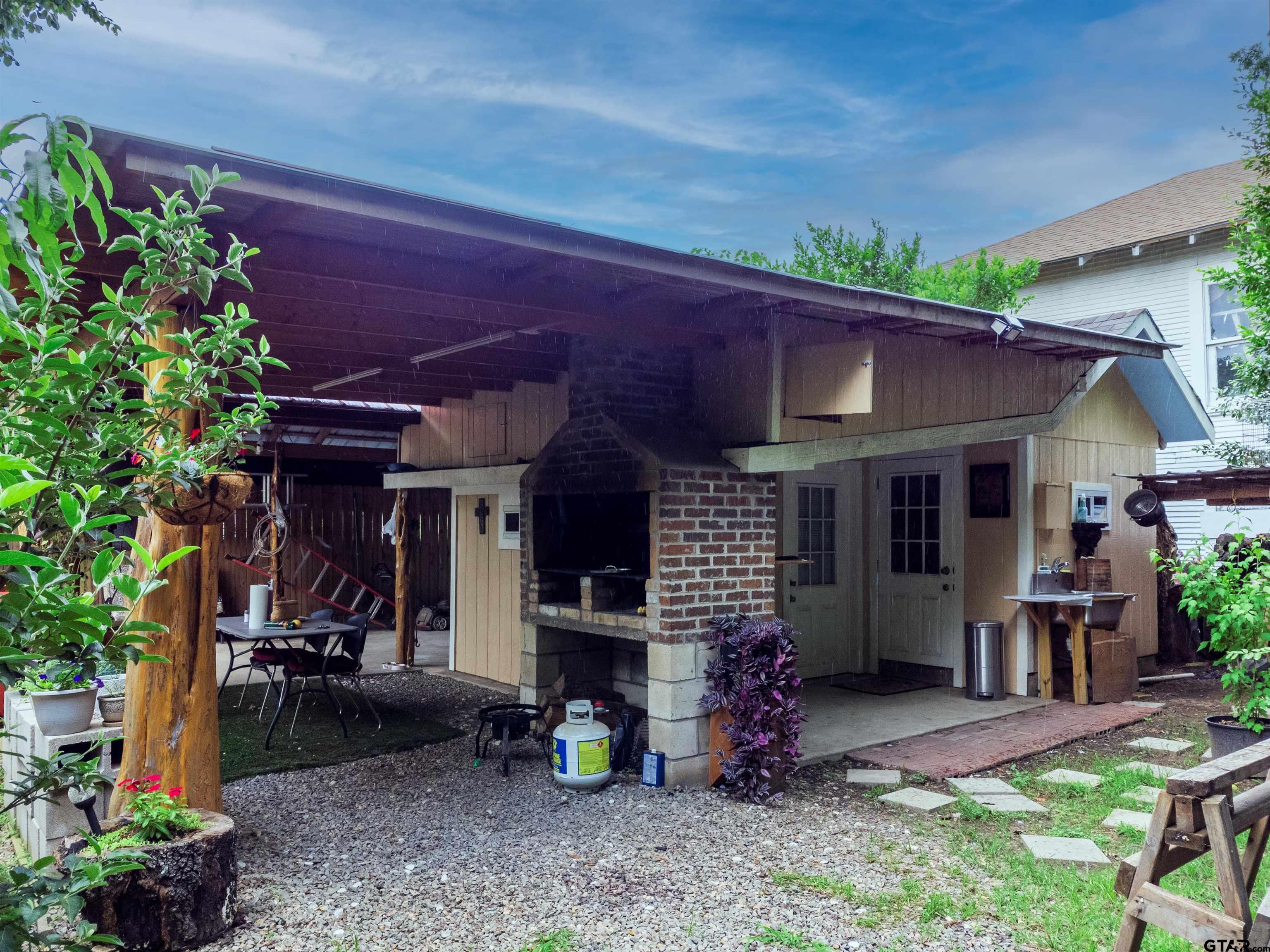 427 East Locust Street Tyler, TX 75702 - Photo 33 of 42 a view of a chair and tables in patio