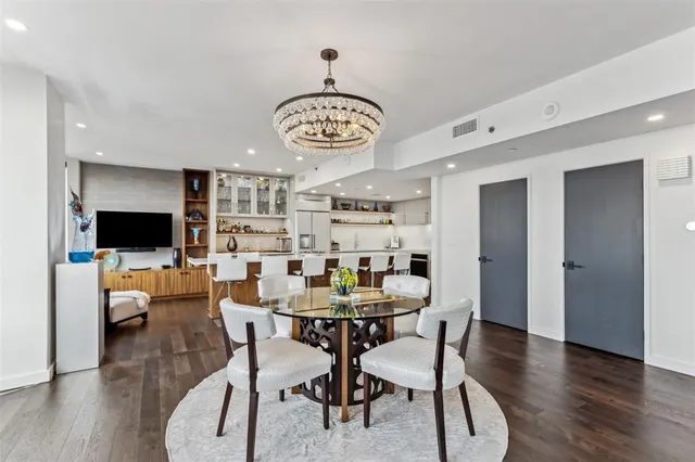 a view of a dining room with furniture wooden floor and a chandelier