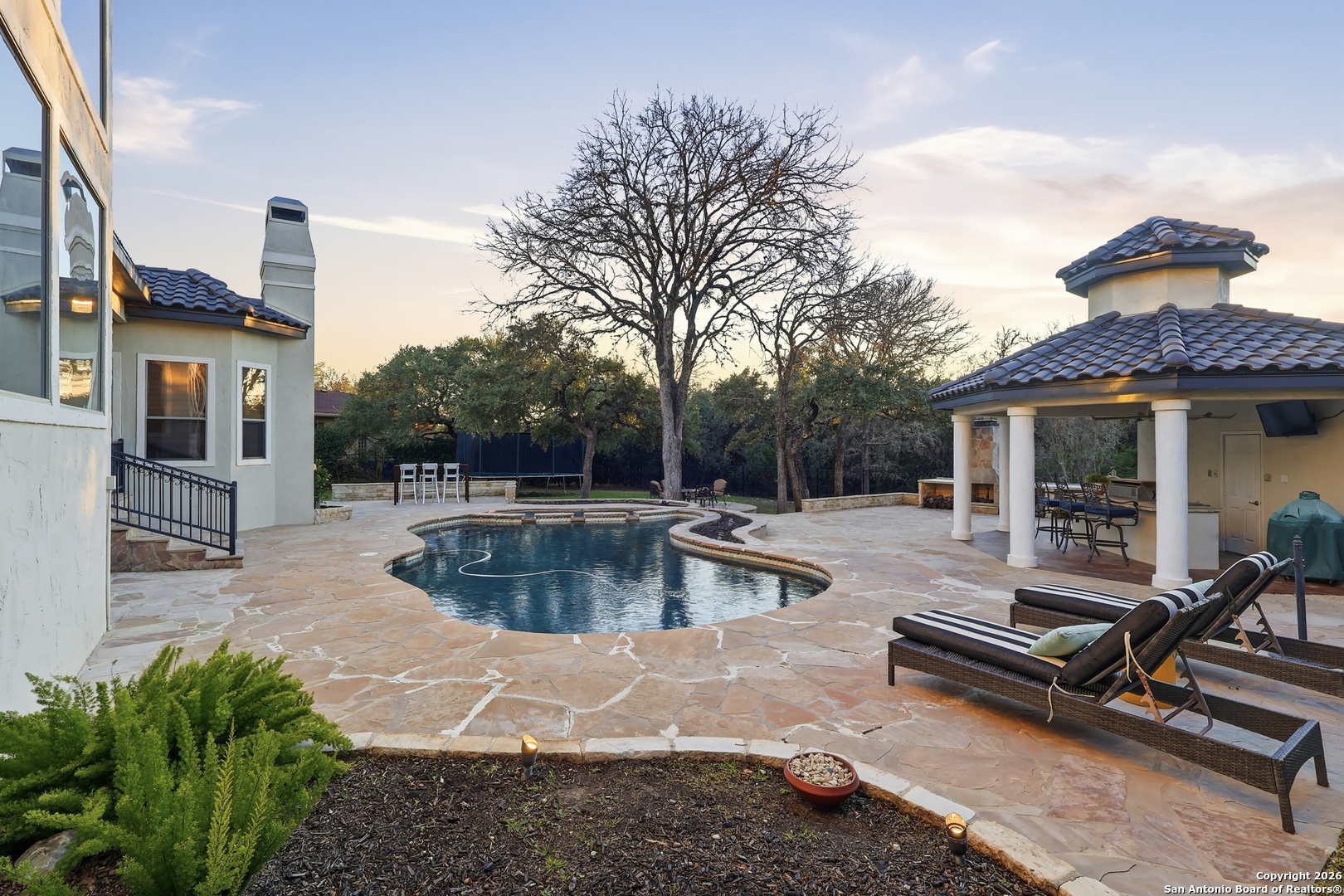 2435 Winding View San Antonio, TX 78260 - Photo 22 of 57 a view of a patio with couches table and chairs with wooden floor and fence