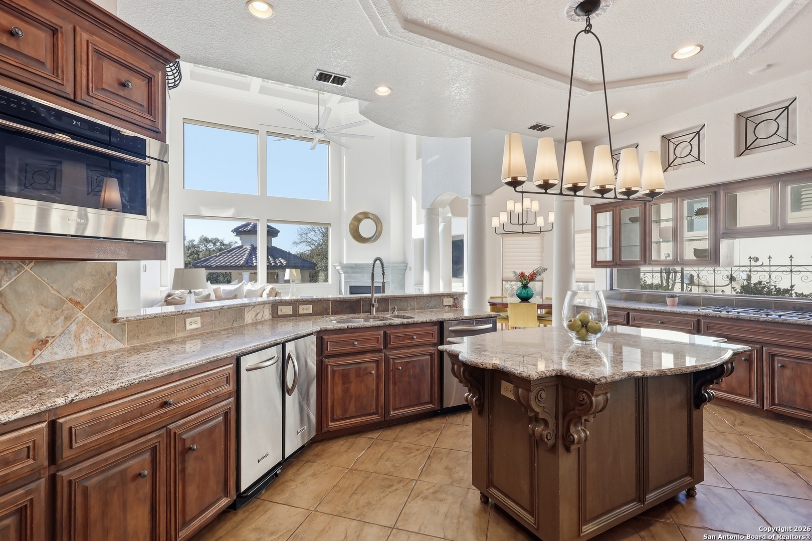 2435 Winding View San Antonio, TX 78260 - Photo 6 of 57 a kitchen with kitchen island granite countertop a sink counter top space appliances and cabinets