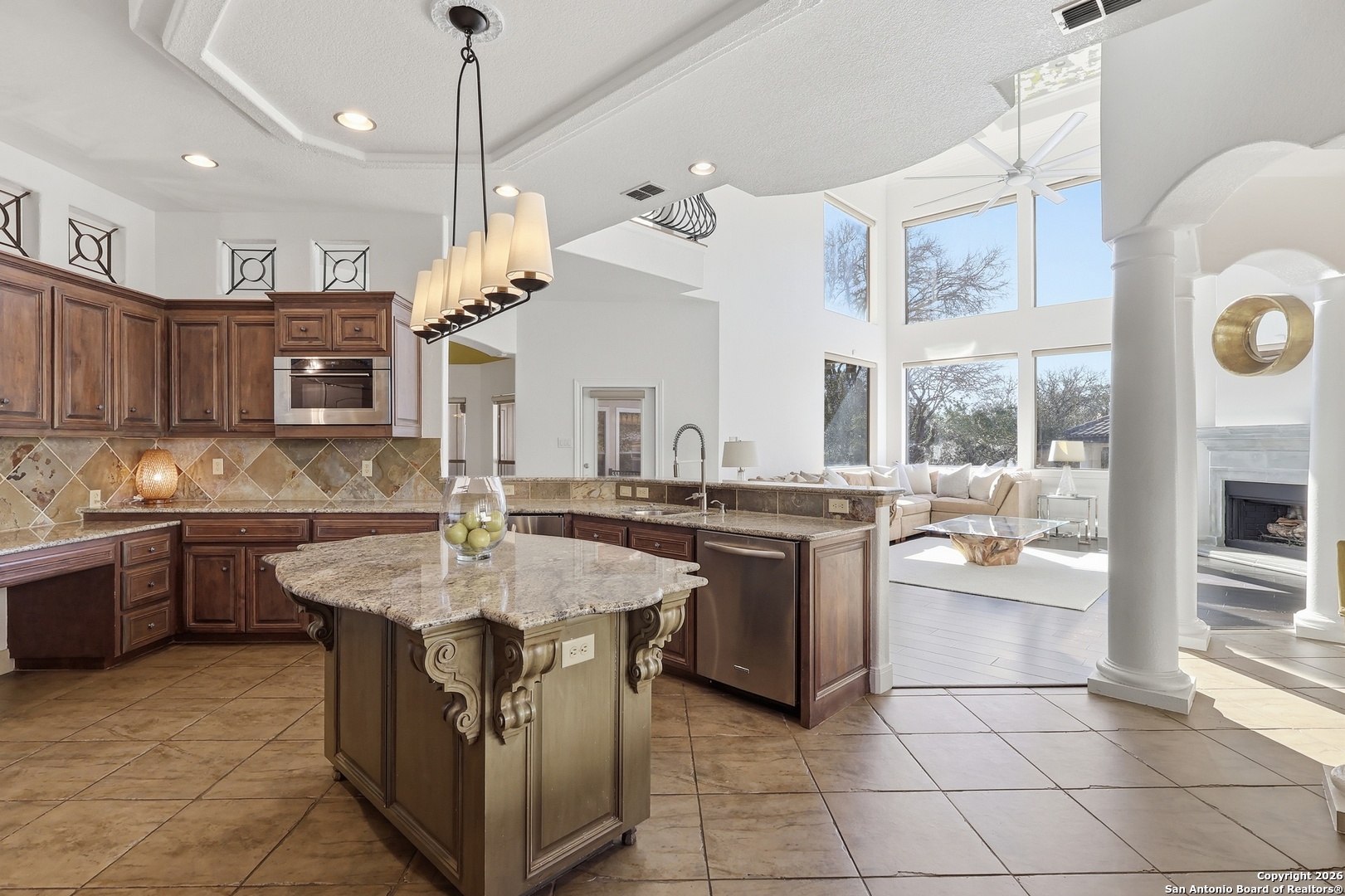 2435 Winding View San Antonio, TX 78260 - Photo 8 of 57 a large kitchen with kitchen island a stove a sink a oven a dining table and chairs