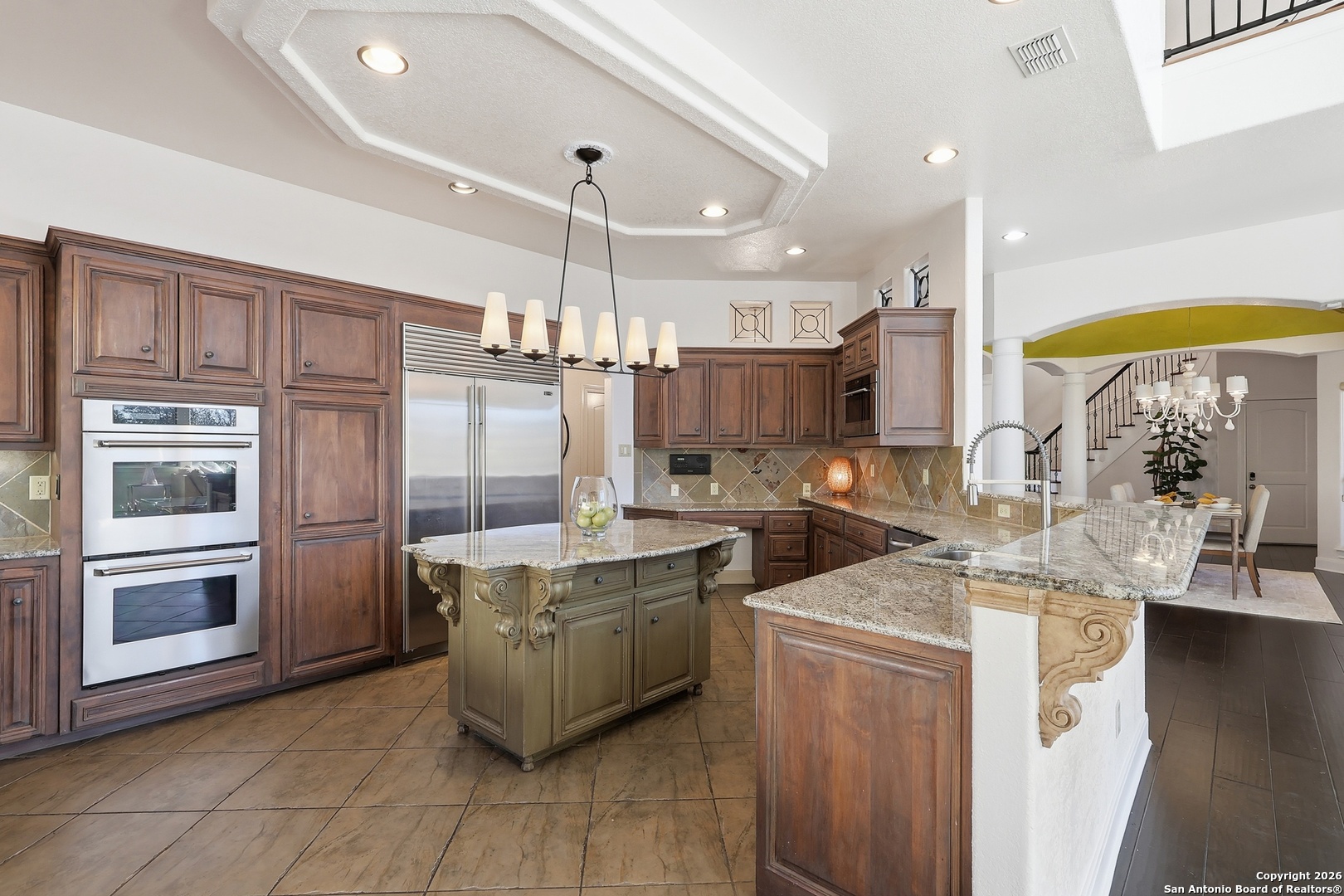2435 Winding View San Antonio, TX 78260 - Photo 9 of 57 a kitchen with stainless steel appliances granite countertop a sink a stove and a refrigerator