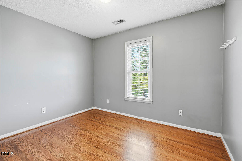 1560 Cane Mill Road Coats, NC 27521 - Photo 26 of 32 a view of an empty room with wooden floor and a window