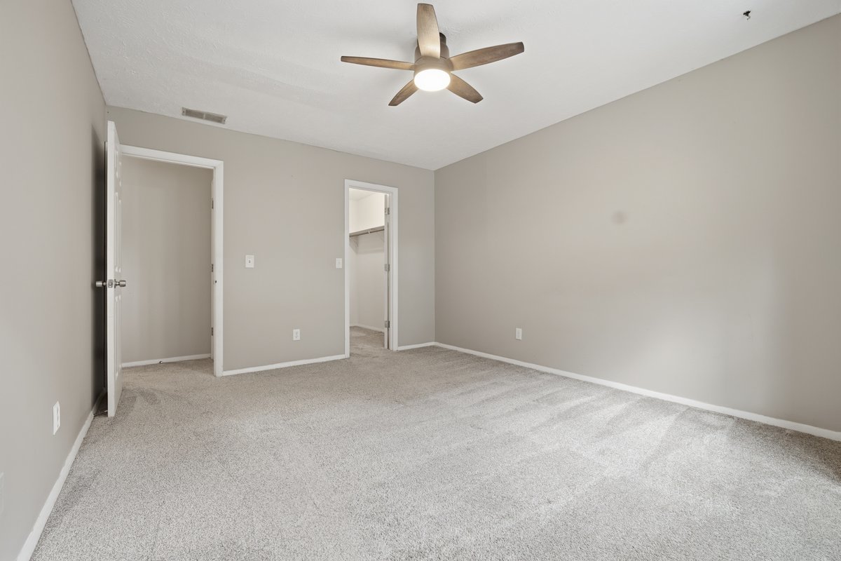 1532 Hunt Drive, Unit A Normal, IL 61761 - Photo 21 of 25 an empty room with chandelier fan